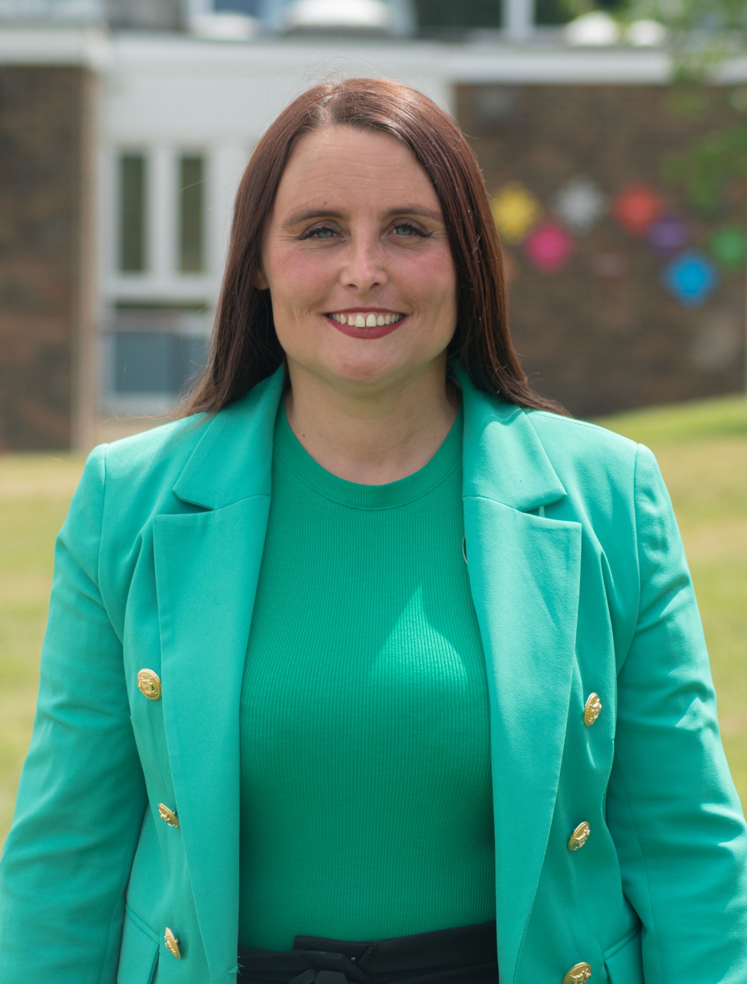 The Head of School smiles at the camera.